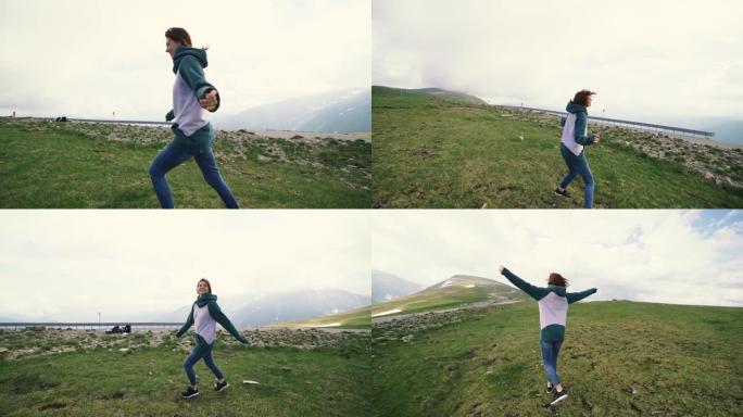 一个年轻的女徒步旅行者在山顶上奔跑和旋转。Trancalpina，罗马尼亚喀尔巴阡山脉慢动作