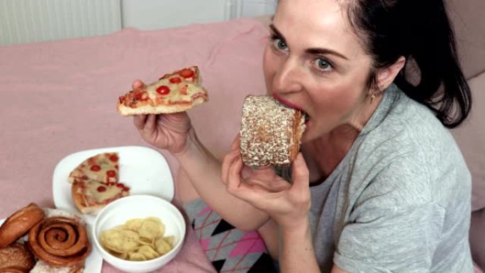 女人吃甜面包和披萨。不良不健康饮食营养观念