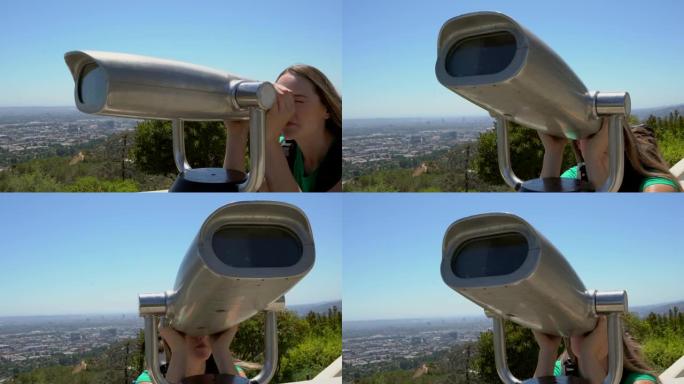白人妇女通过双目望远镜看着城市天际线
