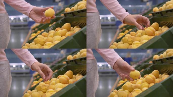女性手在超市采摘水果。
