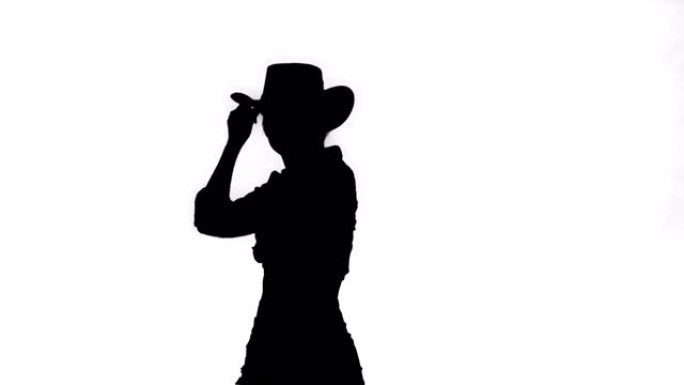 剪影年轻女子在牛仔帽跳舞