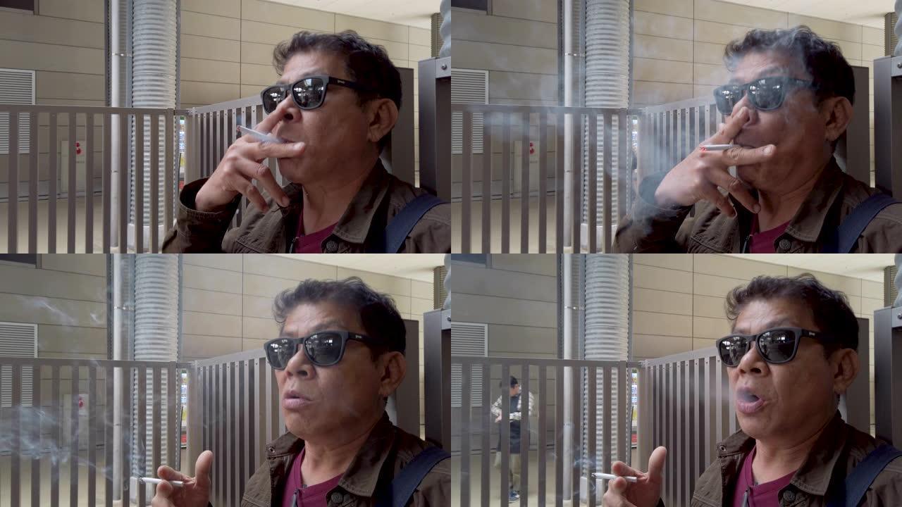 戴墨镜的老人抽烟