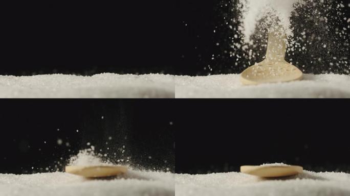 慢动作: 带有盐的木勺落在盐上-飞溅