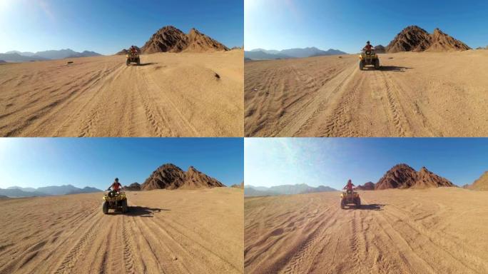 性感的女人在埃及的沙漠里骑着四轮摩托。运动中的动态视图