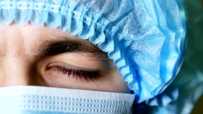 男士外科医生眼睛的宏观特写，带面罩的医生