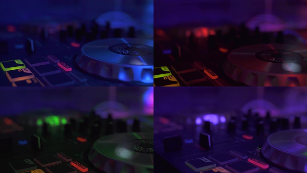 DJ音响控制台，用于在迪斯科俱乐部的夜间派对上与彩色灯光混合音乐。迪斯科派对的特写DJ混音器和音乐控