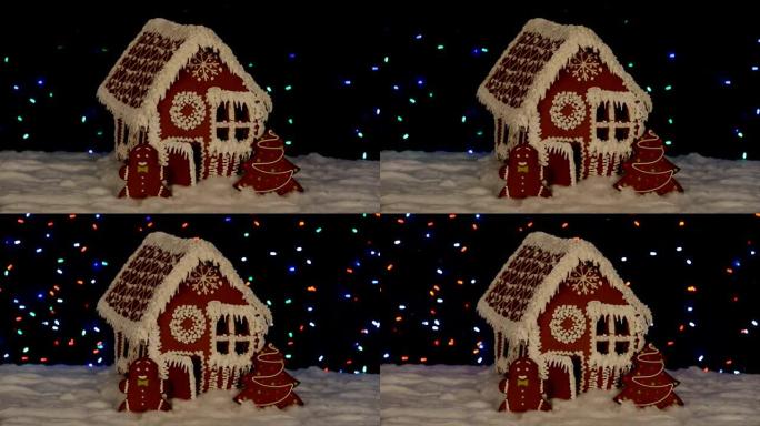 手工制作的可食用姜饼屋，小矮人，新年树，雪装饰，花环背景照明