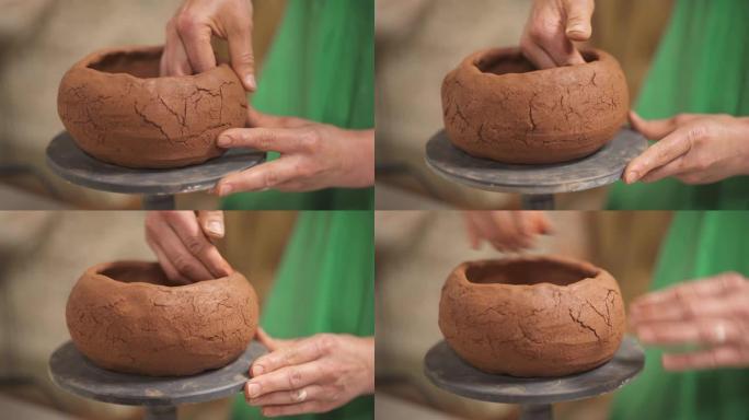花盆创作。熟练的波特在旋转支架上成型陶瓷碗。传统雕刻概念