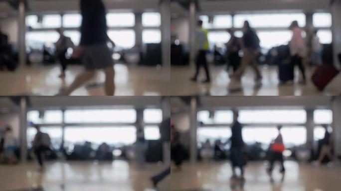 旅行者走到他们的大门时，被大型机场窗户所吸引