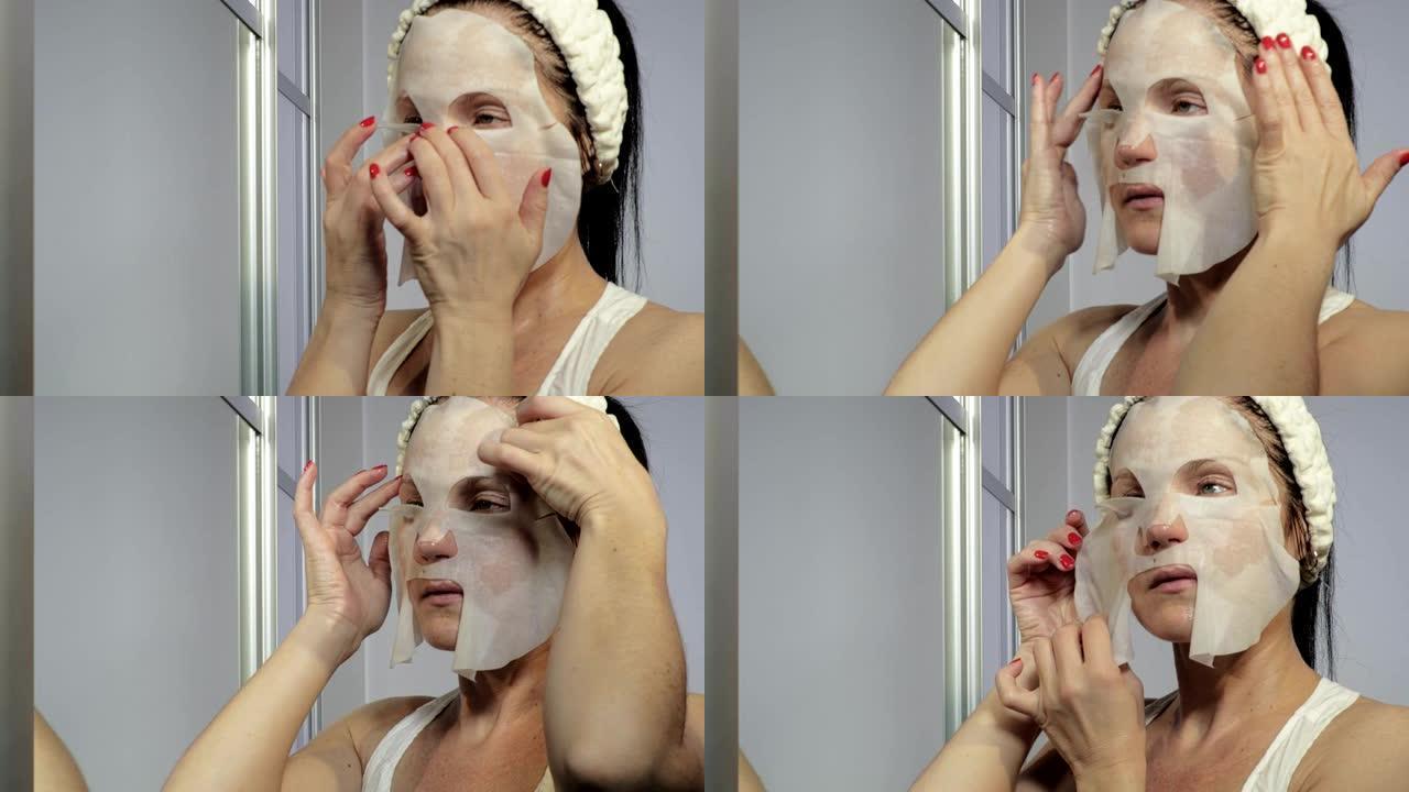 靠近镜子的女人在脸上涂抹面膜
