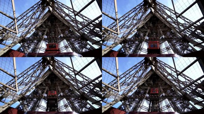 埃菲尔铁塔升降机将乘客带到观景台。它们位于塔的腿上，并遵循结构的曲率