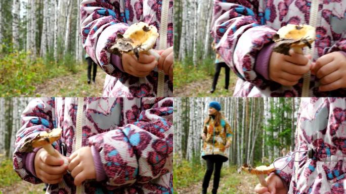 妈妈教她的小女儿采蘑菇。