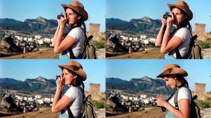 热情的年轻潮女使用专业相机拍摄山地自然摄影