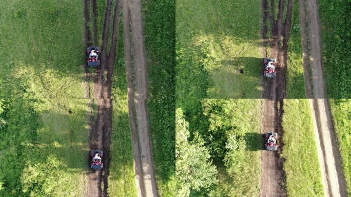 夫妇正在骑四轮摩托车。一对年轻游客的无人机空中射击正在日落时欣赏美丽的山脉景观