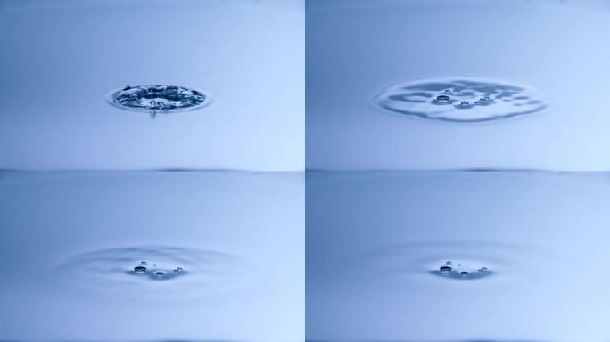 慢动作水滴溅入平静的水中-使用超高速相机拍摄