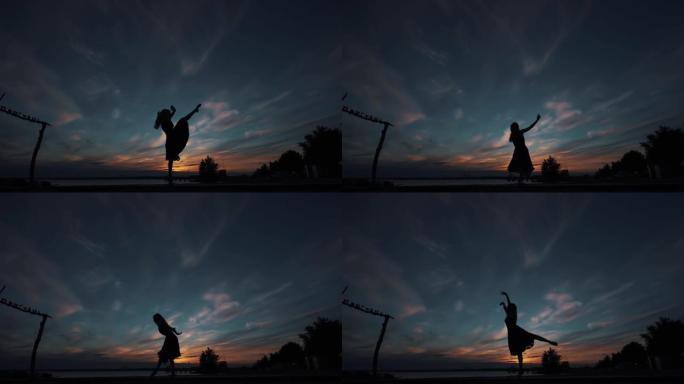 芭蕾舞演员在日落天空下的剪影。这个女孩踮起脚尖跳得很漂亮。