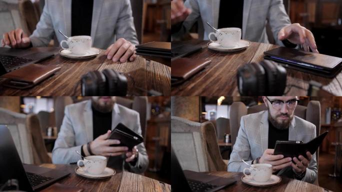 服务员以智能手机平板电脑的形式带来餐厅的电子菜单或账单，并带有内置广告。戴着眼镜，留着胡子的年轻人。