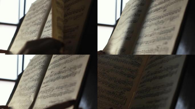 女人钢琴家在白天用两只手翻过音符的特写镜头