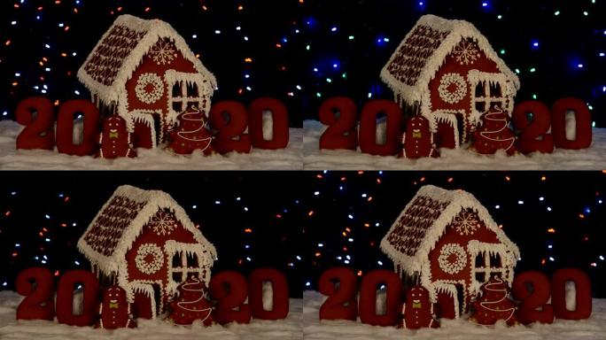 手工制作的可食用姜饼屋，2020铭文，小矮人，新年树，雪装饰，花环背景照明