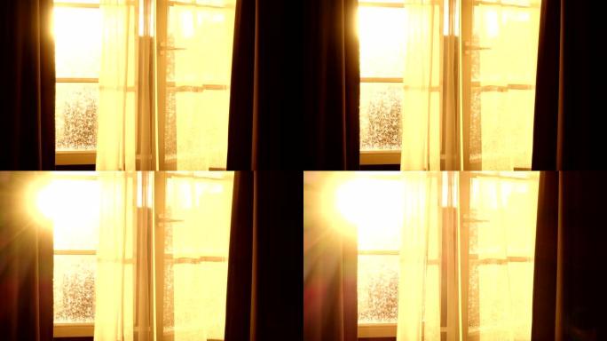 阳光透过打开窗户的透明窗帘，在美丽的红日映照下，微风轻拂