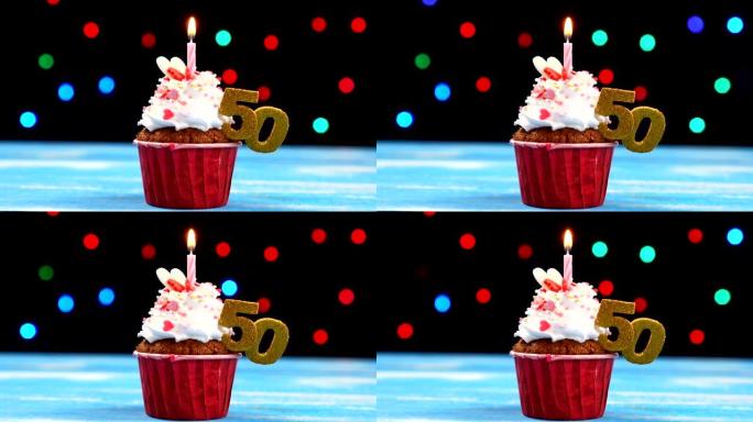 美味的生日蛋糕，蜡烛燃烧，五彩模糊灯光背景上有50号