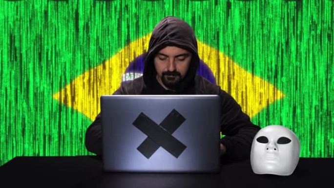 黑客在带有巴西国旗的笔记本电脑上键入代码黑客，背景中有代码动画覆盖