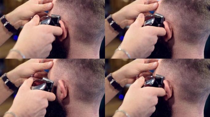 近距离拍摄使用特殊刷子，用电动剃须刀机在男性头部的耳朵附近剃毛，后视图