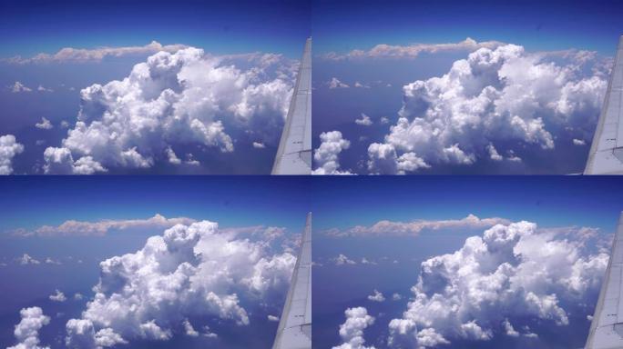蓝天，飞机上的白云透过云背景上方的窗户看。旅游和旅游概念。4k视频。
