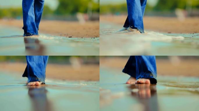 岸边的海浪打湿了他们的赤脚，女孩在海上。特写。