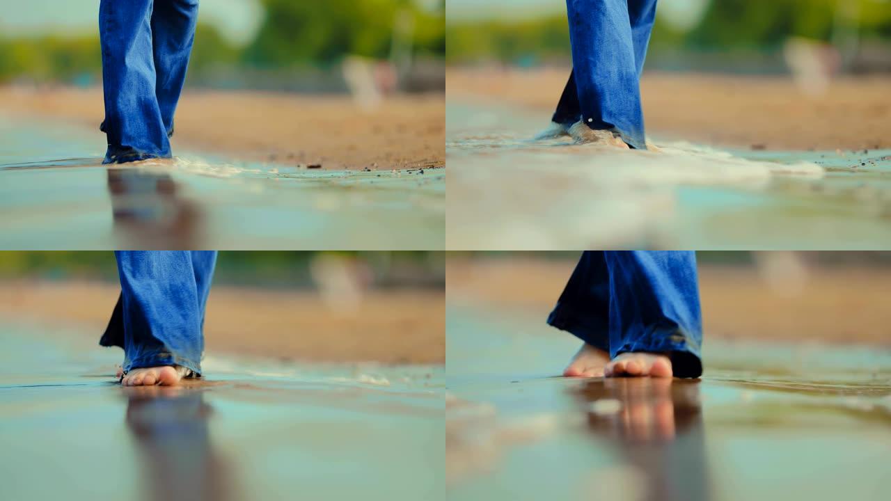 岸边的海浪打湿了他们的赤脚，女孩在海上。特写。