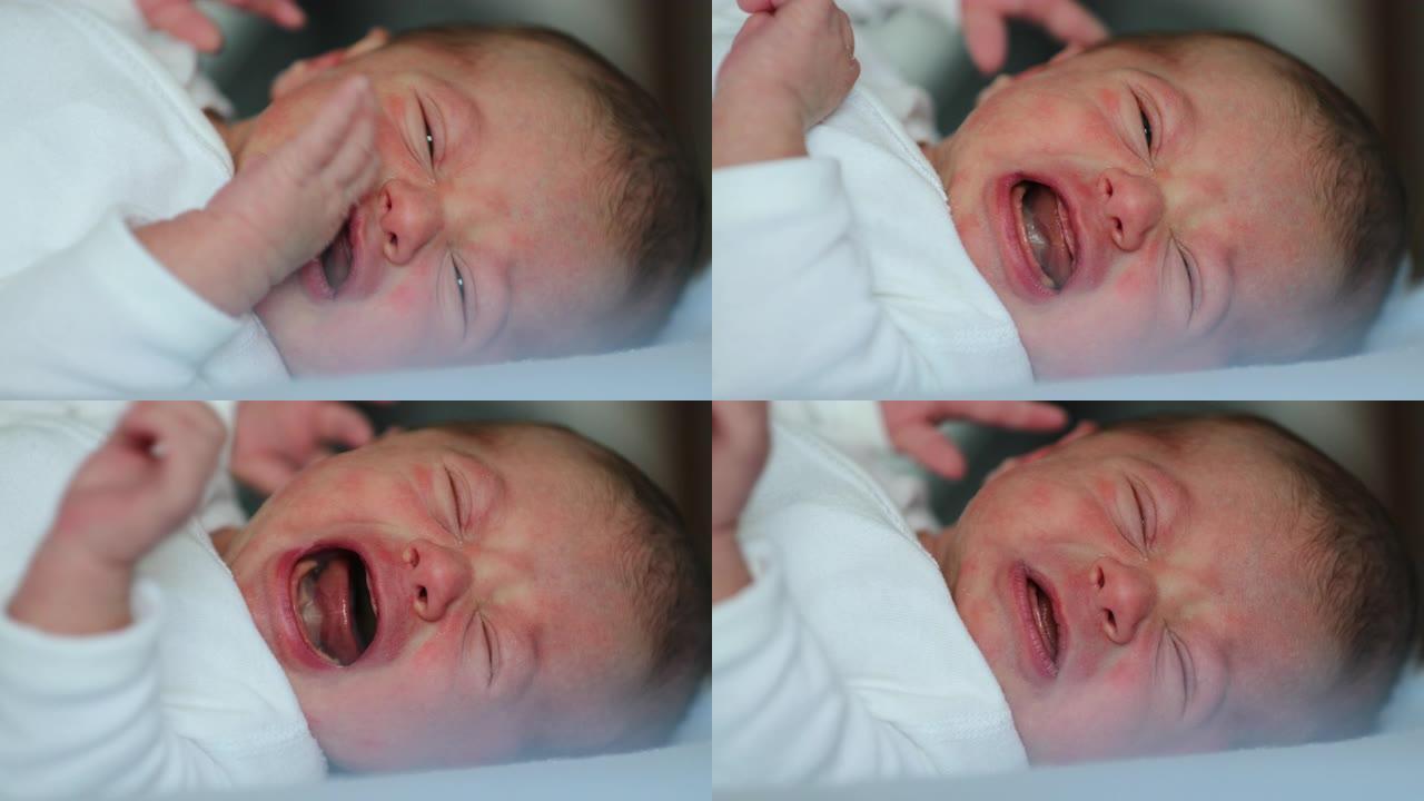 新生婴儿婴儿在生命的第一周哭泣，婴儿脸部特写