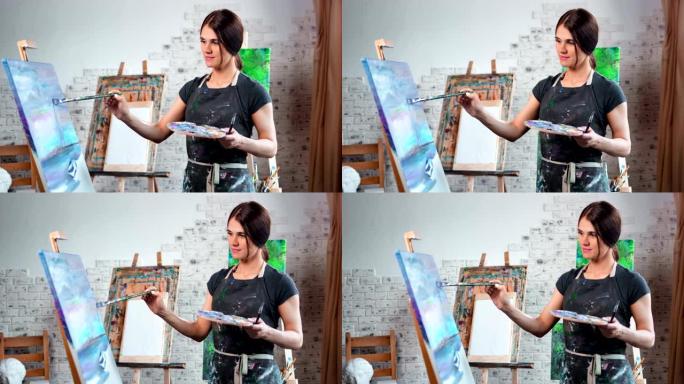 才华横溢的年轻女画家喜欢用画笔中拍在画布上画画