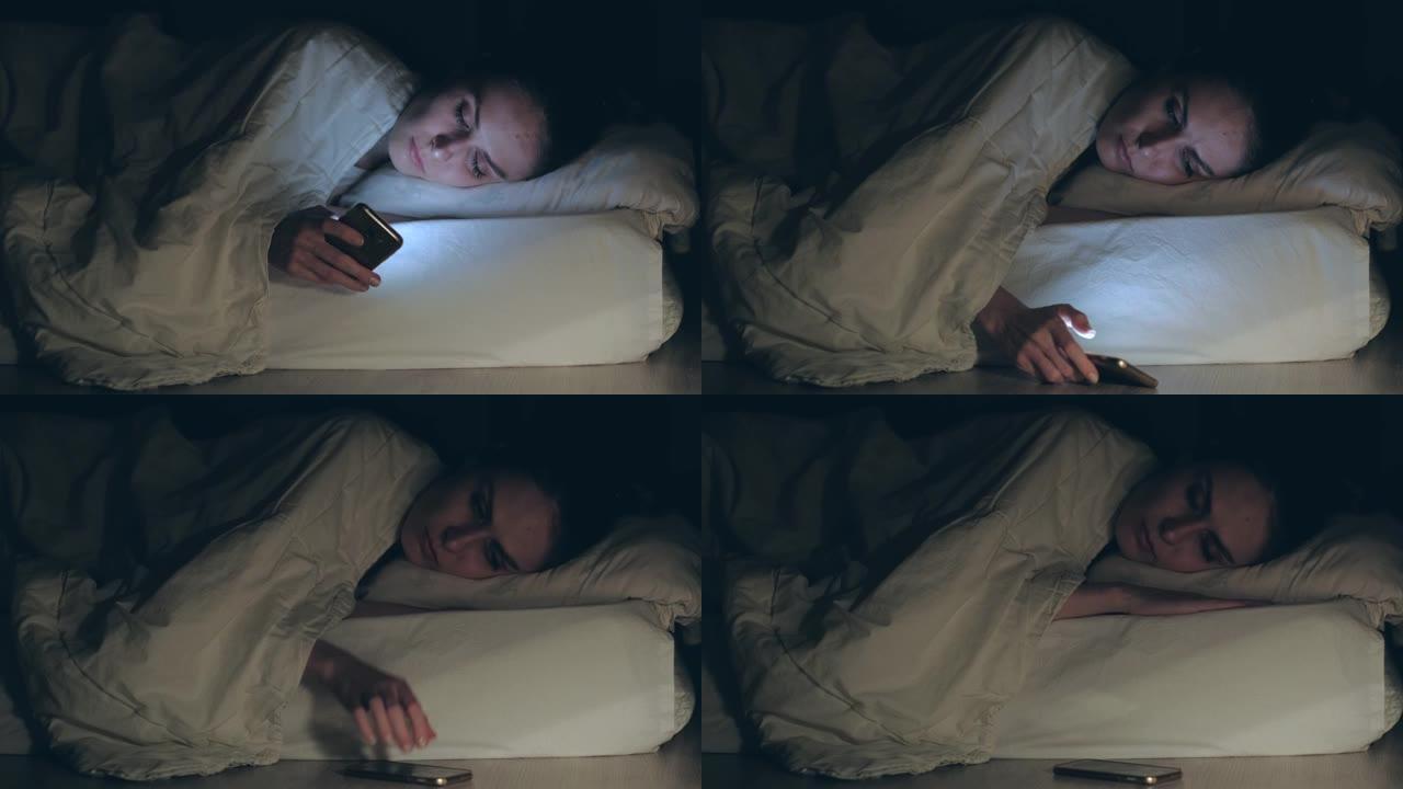 女人躺在床上，睡着了，放下并关闭智能手机