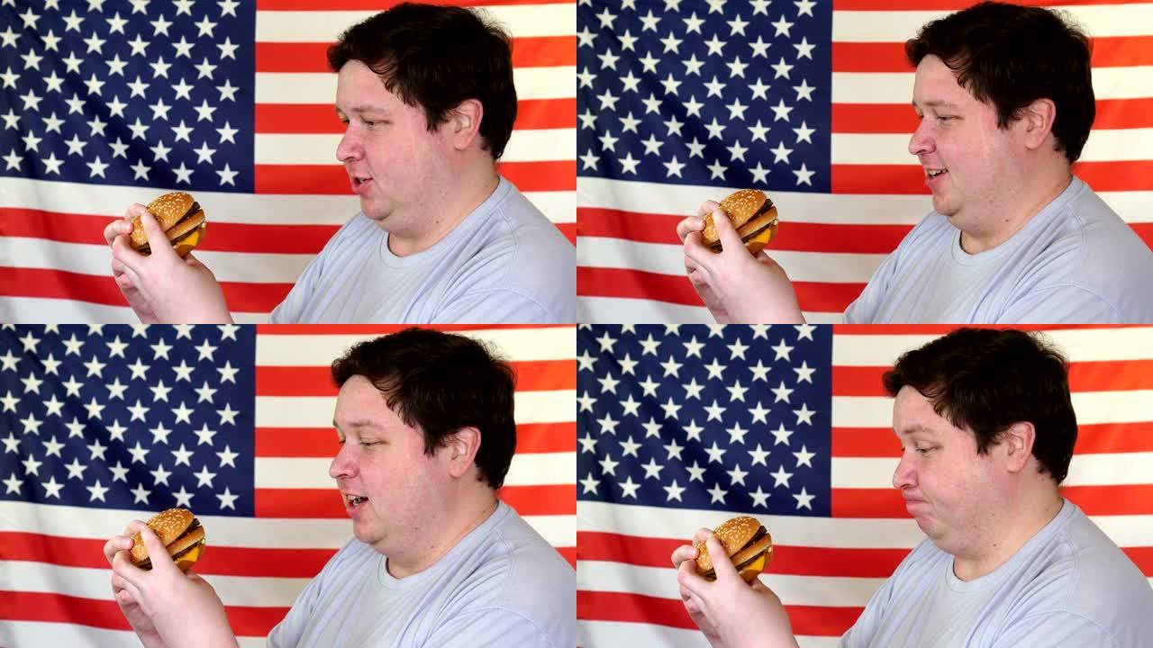 年轻的大男人，胖脸喜欢吃孤立在美国国旗背景上的汉堡