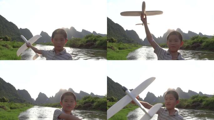 亚洲男孩在户外玩模型飞机