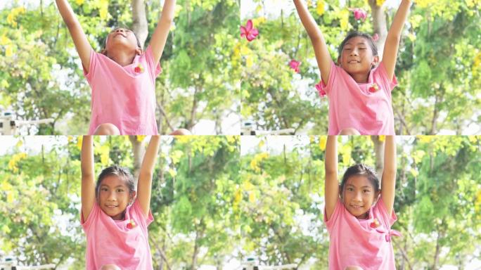 亚洲女孩扔粉红色的花朵，让摔倒，慢动作。