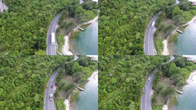 飞越沿着海岸的柏油路。车辆沿着道路行驶