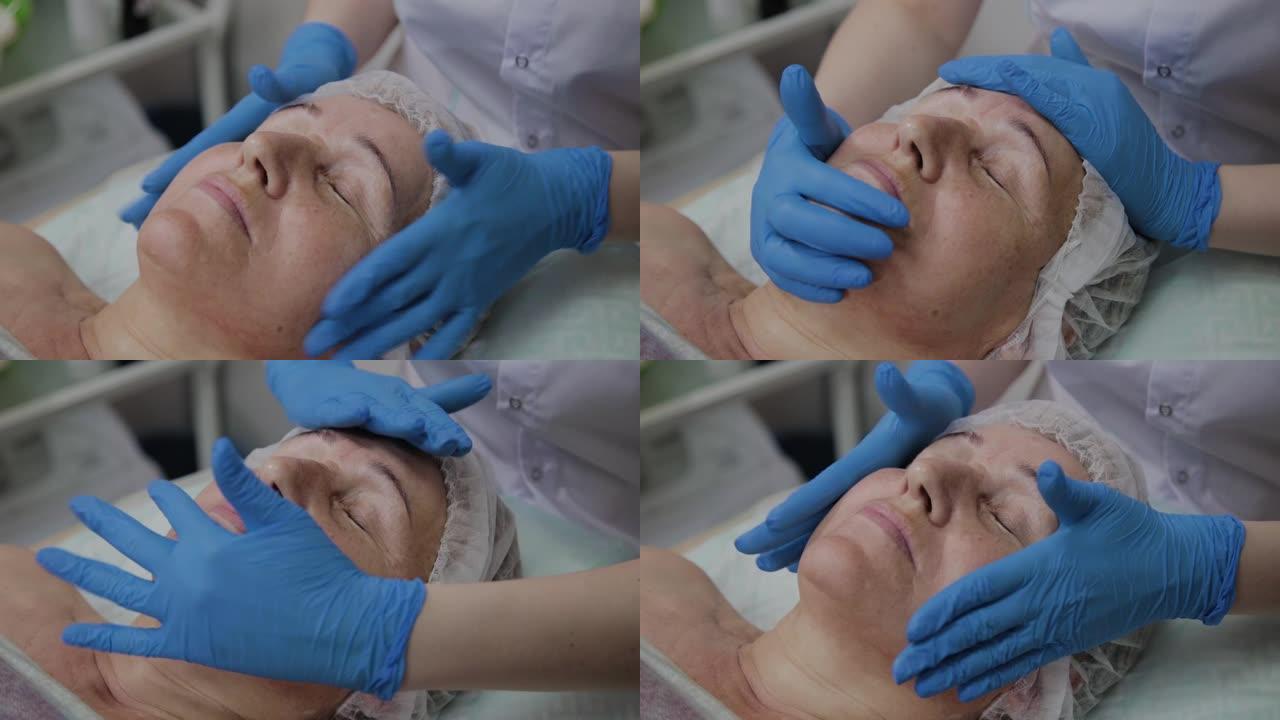 女性美容师在美容诊所对老年妇女进行面部按摩