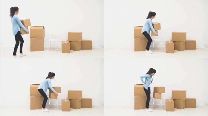 坚强的女人正在搬运一个大的移动盒子，里面装满了物品，孤立在白色背景上。4K。
