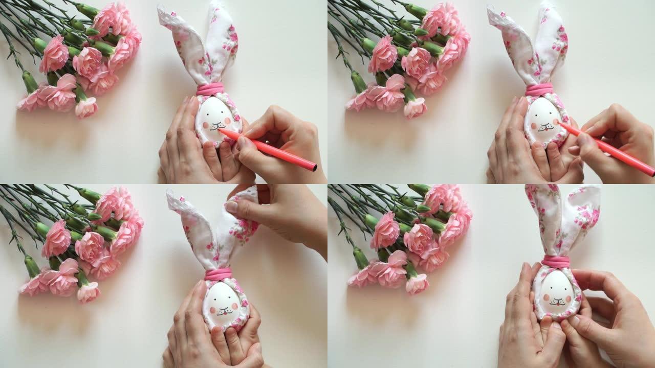 妇女和儿童的手握着为复活节兔子装饰的鸡蛋，用粉红色的标记画兔子的脸。