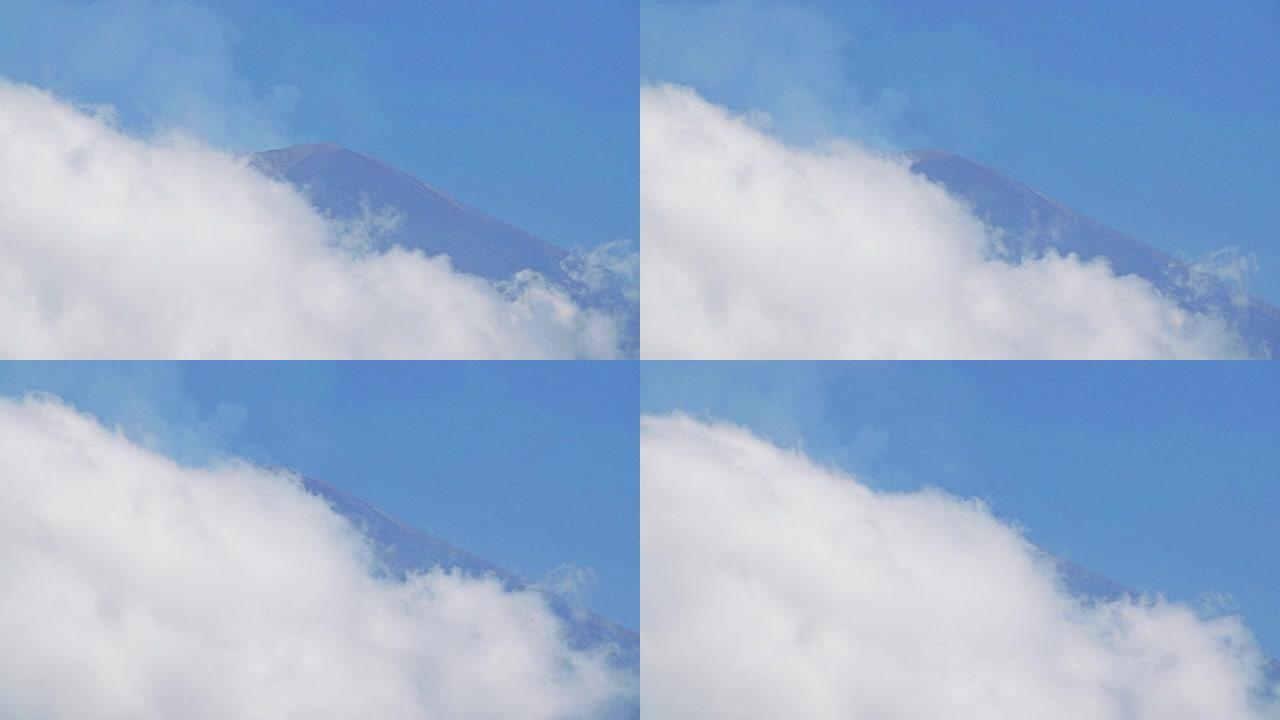 最后一次熔岩喷发几周后，阿贡山2018年7月从火山口和云层下面冒出烟雾。