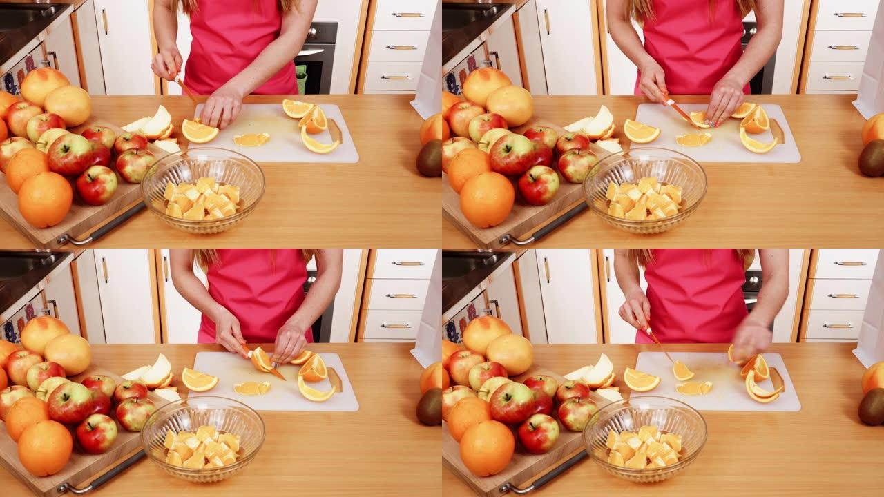厨房里的女家庭主妇切橙色水果4K