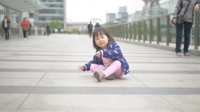 走在上海大街上的蹒跚学步的女孩