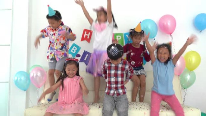 一群亚洲孩子一起庆祝生日派对。生日派对小女孩快乐兴奋的五彩纸屑。