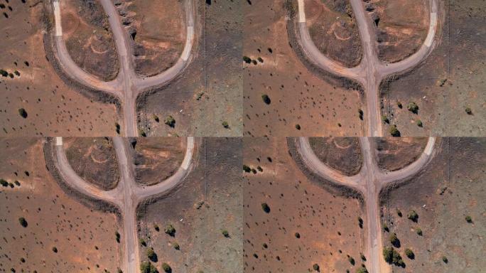 新墨西哥州埃奇伍德附近沙漠中的老肮脏乡间小路。带有平移摄像机运动的空中无人机视频