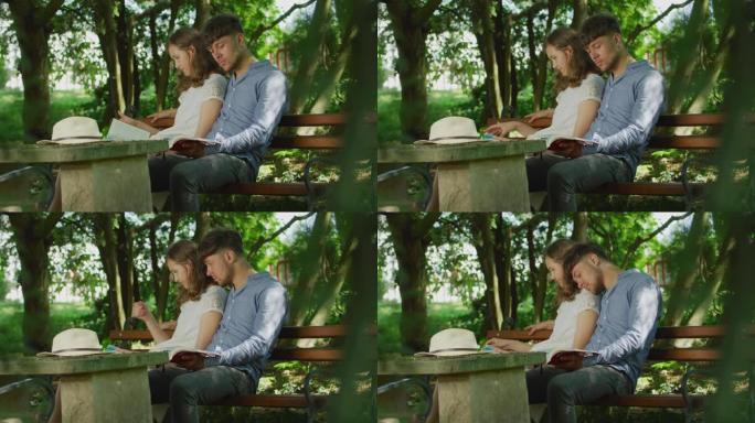 夫妇坐在长凳上看书