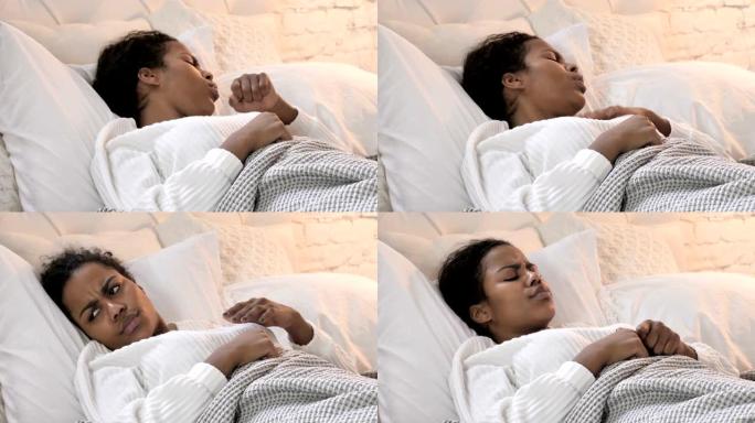 生病的年轻非洲妇女在床上睡觉时咳嗽
