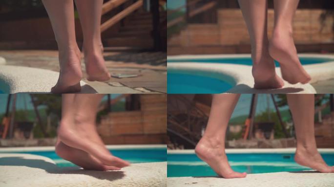 女人在游泳池边缘tip脚时的双腿特写。