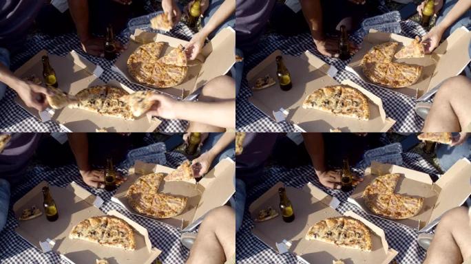 野餐时朋友吃披萨的短拍。