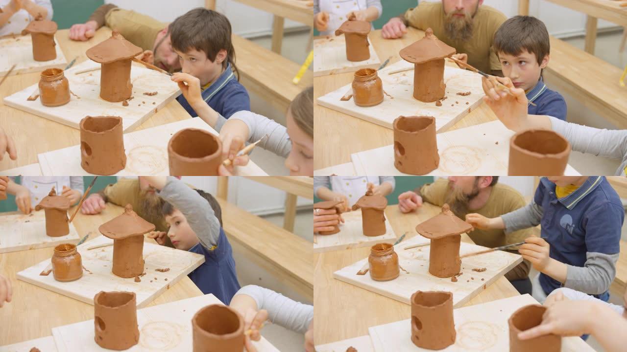 孩子们在教室里制作陶瓷鸟舍